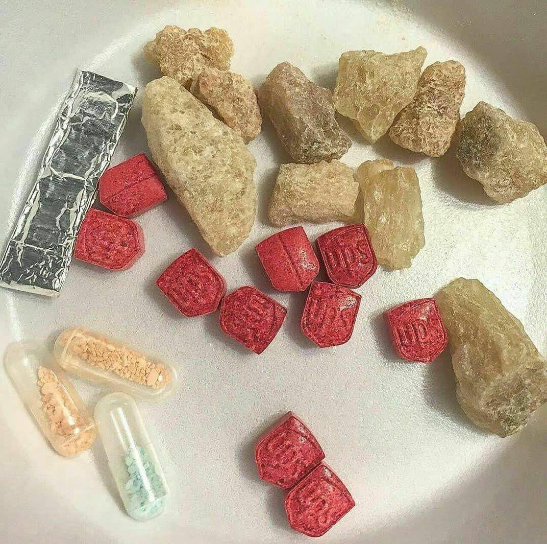 buy-ecstasy-online-canada-molly-tablets-crystals High quality pressed ecstasy tablets and pure champagne molly crystals displayed on a clean surface